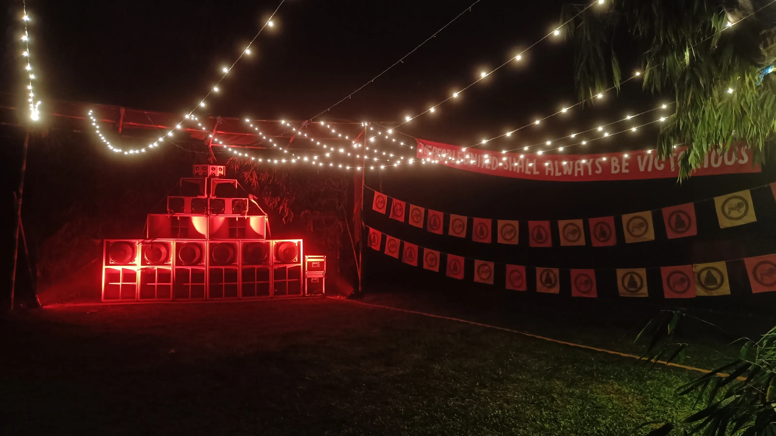 The BFR sound-system booth lit at night, the Studio Monkey Shoulder sign glowing beside the decks
